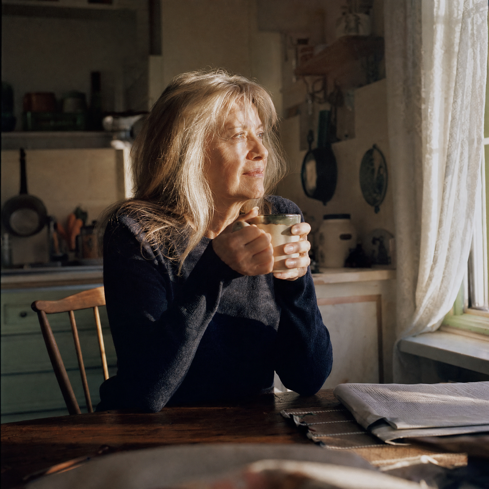 A woman alone at her kitchen window