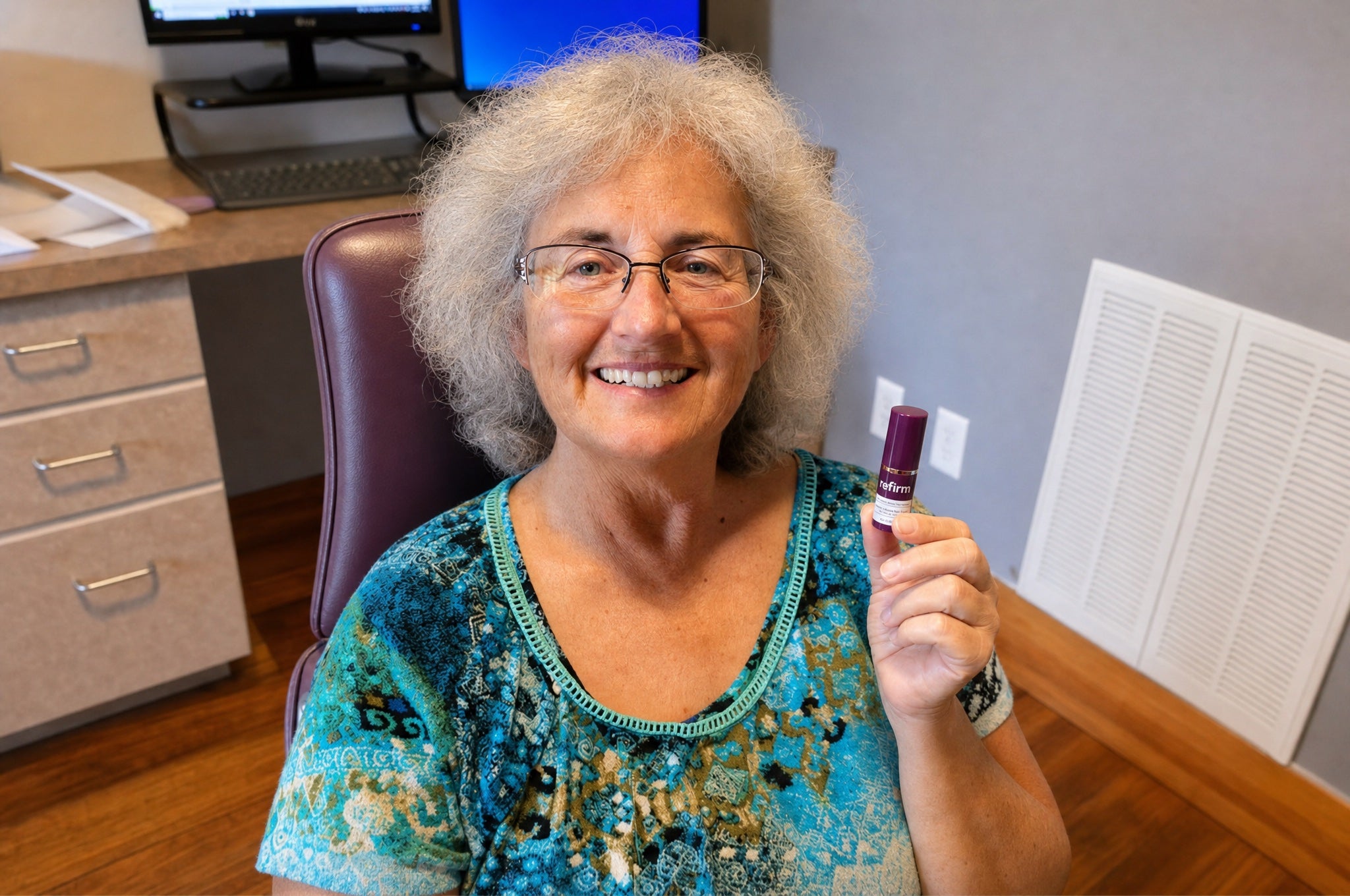 Woman holding Refirm Calcium Balm, smiling